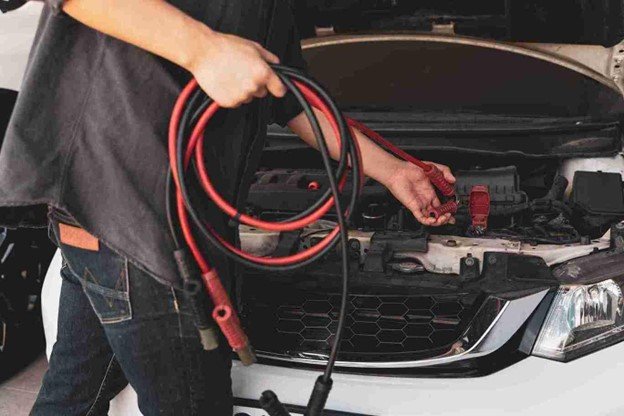 Driver waiting safely on the roadside with a broken-down car
