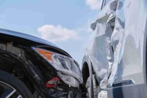 Close-up of two vehicles with visible front-end and side damage after a traffic accident