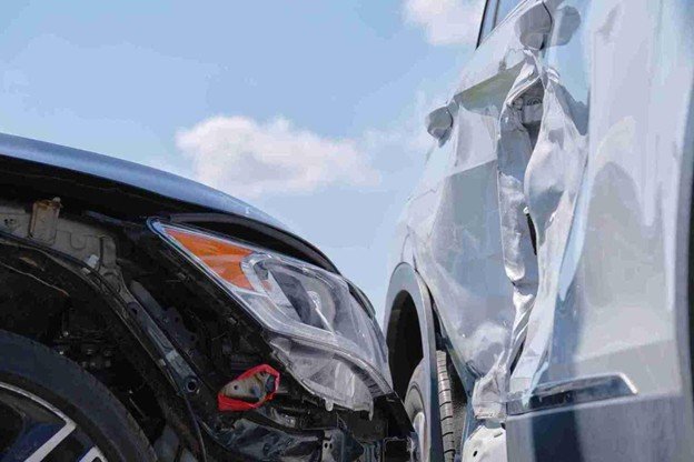 Close-up of two vehicles with visible front-end and side damage after a traffic accident